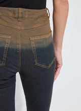 Load image into Gallery viewer, Close-up of model wearing a pair of jeans with a gradient color from brown to black against a white background.