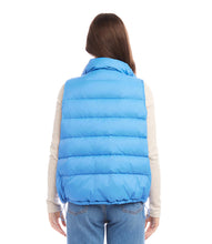 Load image into Gallery viewer, This versatile outerwear option features convenient snaps and a zipper for easy wear and adds just the right amount of insulation when needed. Stand out in style and step into the weather with this cute and feminine vest. Color - Chambray. Length: 24 5/8 inches (size M) Stand collar. Sleeveless. Drawcord-toggle waist. Fabric - Puffer: 100% Nylon.