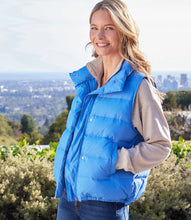 Load image into Gallery viewer, This versatile outerwear option features convenient snaps and a zipper for easy wear and adds just the right amount of insulation when needed. Stand out in style and step into the weather with this cute and feminine vest. Color - Chambray. Length: 24 5/8 inches (size M) Stand collar. Sleeveless. Drawcord-toggle waist. Fabric - Puffer: 100% Nylon.
