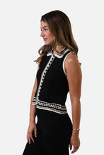 Load image into Gallery viewer, Woman wearing sleeveless black top with black and cream crochet trim and black pants against a white background.