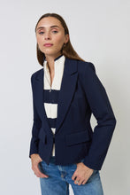 Load image into Gallery viewer, Woman wearing a navy blazer with a striped dickey and blue jeans against a plain background.