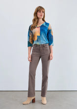 Load image into Gallery viewer, Woman wearing a colorful top, taupe pants and tan boots against a white background.