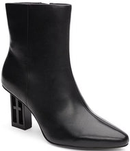 Load image into Gallery viewer, These booties feature an iconic logo on the heel block, adding a striking touch of sophistication. Perfect with casual wide-leg jeans or an elegant dress, they enhance any ensemble with their contemporary style and streamlined design.