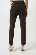 Load image into Gallery viewer, Model wearing mocha slim fitting pants and off-white heels against a white background.