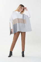 Load image into Gallery viewer, Experience a perfect balance of fashion and comfort in this Joseph Ribkoff tunic sweater. Crafted with an easy-fit silhouette and a contemporary color-blocked design, it's an ideal addition to your everyday wardrobe. Beautifully pairs with our Natalia Nutmeg Faux Leather Pants - Joseph Ribkoff 223196 as pictured. Color- Tan, grey, white. Turtleneck. Colorblock. No pockets. Fabric-48% Rayon. 30% Polyester. 22% Nylon.