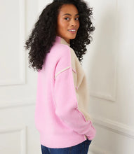 Load image into Gallery viewer, Woman wearing a sand and pink colorblock sweater and jeans against a white wall.