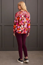 Load image into Gallery viewer, Steal the spotlight in this vibrantly printed blouse cut from flowy challis fabric with a hint of stretch. The popover v-neck, highlighted by delicate fabric ties, features a shirttail hem and long sleeves with elastic cuffs, completing the design. It seamlessly adds sophisticated style and vibrant color to your ensemble.