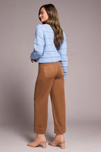Load image into Gallery viewer, Woman wearing a light blue sweater. brown pants and tan boots against a neutral background.