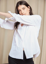 Load image into Gallery viewer, The Connie Slim Button Down boasts a slimmer fit with a curved, hip-length hem that extends longer in the back than the front. Made from travel-friendly, wrinkle-resistant Microfiber, this top pairs seamlessly with bootcut jeans, sandals, and a vegan suede jacket.