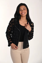 Load image into Gallery viewer, Woman wearing a modern black dot jacket over a black tank and tan pants against a white background.