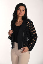Load image into Gallery viewer, Woman wearing a modern black dot jacket over a black tank and tan pants against a white background.