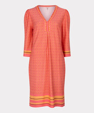 Load image into Gallery viewer, This timeless dress is a customer favorite. This season it is offered in a gorgeous coral color with timeless chain print and cute beading along the v-neckline. The dress is approximately knee length and has a three-quarter length sleeve.