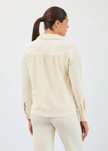 Load image into Gallery viewer, Woman wearing small gold hoop earrings, creme corduroy long sleeve top and matching pant against a neutral background.