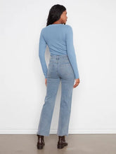 Load image into Gallery viewer, A woman shown from the back wearing a light blue long-sleeve knit top and light blue corduroy pants, paired with dark brown ankle boots, against a plain white wall.