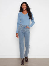 Load image into Gallery viewer, Woman modeling light blue corduroy pants with a blue top and brown boots against a white wall.