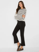 Load image into Gallery viewer, Woman wearing a black and cream striped fuzzy sweater, black pants and black flats against a white background.