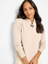 Load image into Gallery viewer, Woman wearing a beige sweater with a metallic closure detail against a white background.