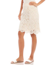 Load image into Gallery viewer, Embrace timeless elegance with the Crochet Skirt in Natural by Karen Kane. Crafted from premium cotton and adorned with intricate hexagon embroidery, this skirt is a perfect blend of sophistication and comfort. Its A-line silhouette and elastic waistband ensure effortless wearability, while its versatility makes it ideal for casual outings or dressed-up occasions. Add a touch of charm to your wardrobe with this beautifully designed piece.