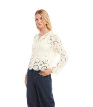 Load image into Gallery viewer, Woman wearing a cream crochet jacket and blue jeans on a white background.