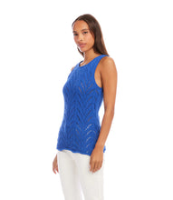 Load image into Gallery viewer, Woman wearing a blue sleeveless top and white pants against a white background.