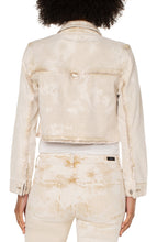 Load image into Gallery viewer, Add this fabulous, cropped denim layering piece to your entire look to add an edge to your outfit. Cropped at the waist, our Cynthia is the perfect length for versatility. The frayed hem and tie dye wash makes this unique style a fantastic choice for any outfit. For an effortless look, layer over an easy knit top with a looser fitting bottom for the perfect silhouette. Color - Bisquit Tan Tie Dye; washed light tan. Tie dye Silver buttons and hardware. D-ring on back. Crop style.
