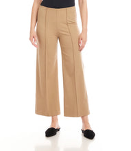 Load image into Gallery viewer, Close-up of model wearing beige cropped pants and black flats against a white background.