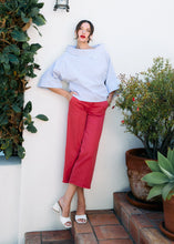 Load image into Gallery viewer, A fresh take on nautical style, this pop-over top blends classic white and blue stripes with a modern crossover neckline, creating a look that’s both timeless and sophisticated. Pairs beautifully with everything from white pants to denim.