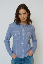 Load image into Gallery viewer, Woman wearing a light blue western style sweater top and blue jeans against a gray background.