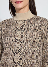 Load image into Gallery viewer, Close-up of a model wearing a lux camel colored snake jacquard patterned sweater against a neutral background.