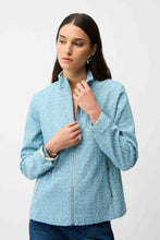 Load image into Gallery viewer, Woman wearing a sequin light blue textured jacket and blue jeans on a white background.