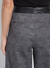 Load image into Gallery viewer, Closeup view of back pockets on the wide leg pants, worn by a model against a white background.