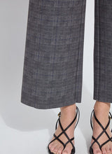Load image into Gallery viewer, Close-up view of the wide leg pant hem and sandals, worn by a model against a white background.