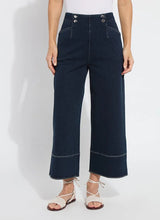 Load image into Gallery viewer, The Dion Sailor Palazzo Denim Pant is a chic sailor-inspired piece, perfect for modern fashion enthusiasts. This cropped wide-leg palazzo pant boasts trendy contrast-color topstitching and is crafted from premium 4-way stretch Knit Denim for comfort and flexibility. Featuring a clean front with a stylish waist seam, functional pockets adorned with metal buttons and eyelets, and back welt pockets, this design combines practicality with elegance.