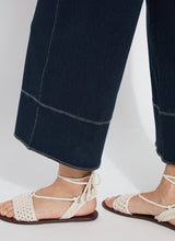Load image into Gallery viewer, The Dion Sailor Palazzo Denim Pant is a chic sailor-inspired piece, perfect for modern fashion enthusiasts. This cropped wide-leg palazzo pant boasts trendy contrast-color topstitching and is crafted from premium 4-way stretch Knit Denim for comfort and flexibility. Featuring a clean front with a stylish waist seam, functional pockets adorned with metal buttons and eyelets, and back welt pockets, this design combines practicality with elegance.