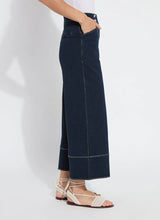 Load image into Gallery viewer, The Dion Sailor Palazzo Denim Pant is a chic sailor-inspired piece, perfect for modern fashion enthusiasts. This cropped wide-leg palazzo pant boasts trendy contrast-color topstitching and is crafted from premium 4-way stretch Knit Denim for comfort and flexibility. Featuring a clean front with a stylish waist seam, functional pockets adorned with metal buttons and eyelets, and back welt pockets, this design combines practicality with elegance.