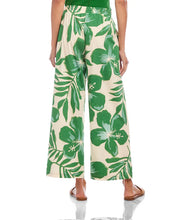 Load image into Gallery viewer, Green and cream floral and leaf patterned pants against a white background.