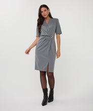 Load image into Gallery viewer, Woman wearing a gray cinched dress with a silver buckle and black boots against a white background.