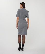 Load image into Gallery viewer, Woman wearing a gray dress and black boots against a white background.