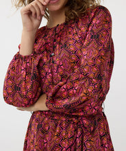 Load image into Gallery viewer, If you're in search of a dress with a distinctive, colorful print, our Sensation print dress is the perfect choice! It features a bow belt and buttons up to the waist. Crafted with an exterior of 100% polyester and a lining of 100% viscose, it not only maintains its beauty over time but also offers comfort.
