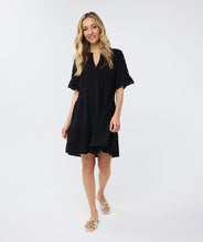 Load image into Gallery viewer, This short-sleeved dress boasts a loose fit and a floaty skirt, creating a hint of playfulness. Made from a waffle fabric, this dress is perfect for summertime, allowing for unrestricted movement and comfort.