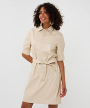 Load image into Gallery viewer, Woman wearing a light sand faux leather dress against a white background.