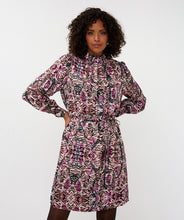 Load image into Gallery viewer, Woman wearing a zebra patterned dress against a white background.