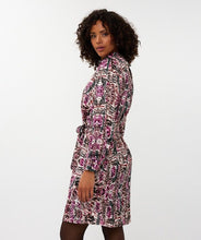 Load image into Gallery viewer, Woman wearing a zebra patterned dress against a white background.