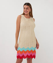 Load image into Gallery viewer, Woman wearing a beige sleeveless dress with colorful zig zag hem on a white background.