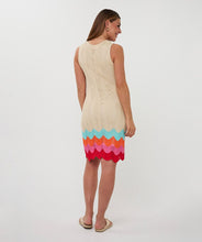Load image into Gallery viewer, Woman wearing a beige sleeveless dress with colorful zig zag hem and tan sandals on a white background.