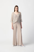 Load image into Gallery viewer, This sleek, silky knit wide-leg pant showcases a flared silhouette that effortlessly goes from day to night. Featuring a button closure and a soft contour waistband for added comfort, this look also includes cargo pockets highlighting this piece’s polished style. Color- Dune. Silky knit. Soft contour waistband. Cargo pockets. Unlined.