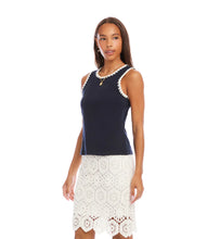 Load image into Gallery viewer, Woman wearing a navy sleeveless top with white crochet trim and a white lace skirt on a white background.