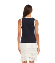 Load image into Gallery viewer, Woman wearing a navy sleeveless top with white crochet trim and a white lace skirt on a white background.