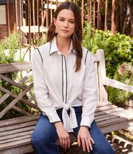 Load image into Gallery viewer, Enhance your outfit with this fashionable Ottilie Off White with Black Edge Stitch Tie Front Top from Karen Kane. Featuring a touch of edginess with contrast stitching detail, this top is designed for both style and comfort. The flattering fit of the tie front and the enhanced look of the stitching detail make this top a must-have for any wardrobe.