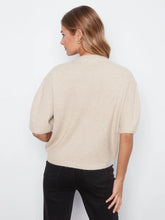 Load image into Gallery viewer, Back view of model wearing an elbow sleeve sweater and black pants against a white wall.